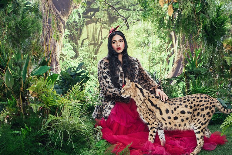 woman wearing faux fur petting serval