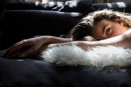 woman lying on faux fur throw