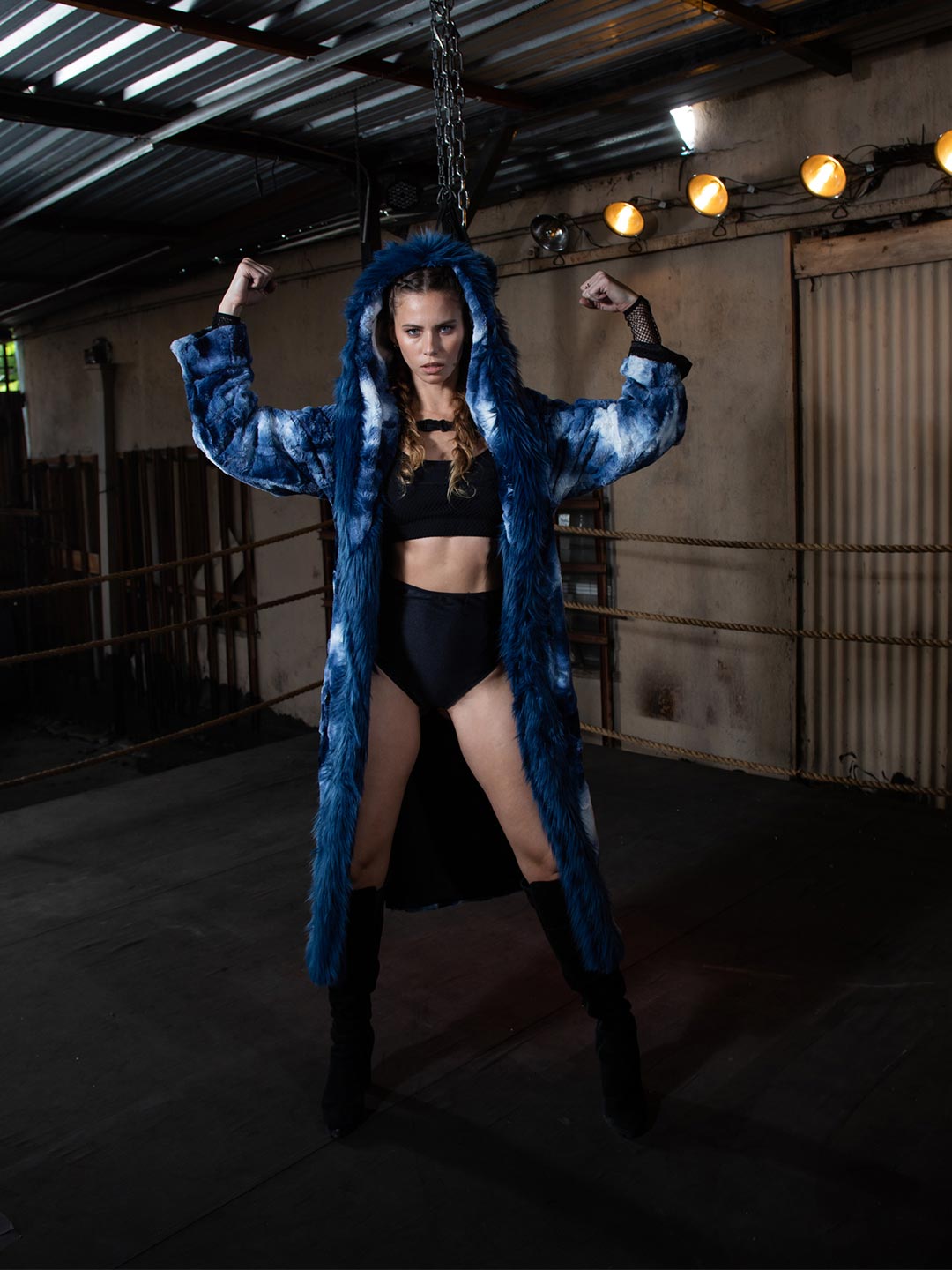 Brunette Model Flexing Her Muscles While Wearing Classic Water Wolf Robe Made of Faux Fur