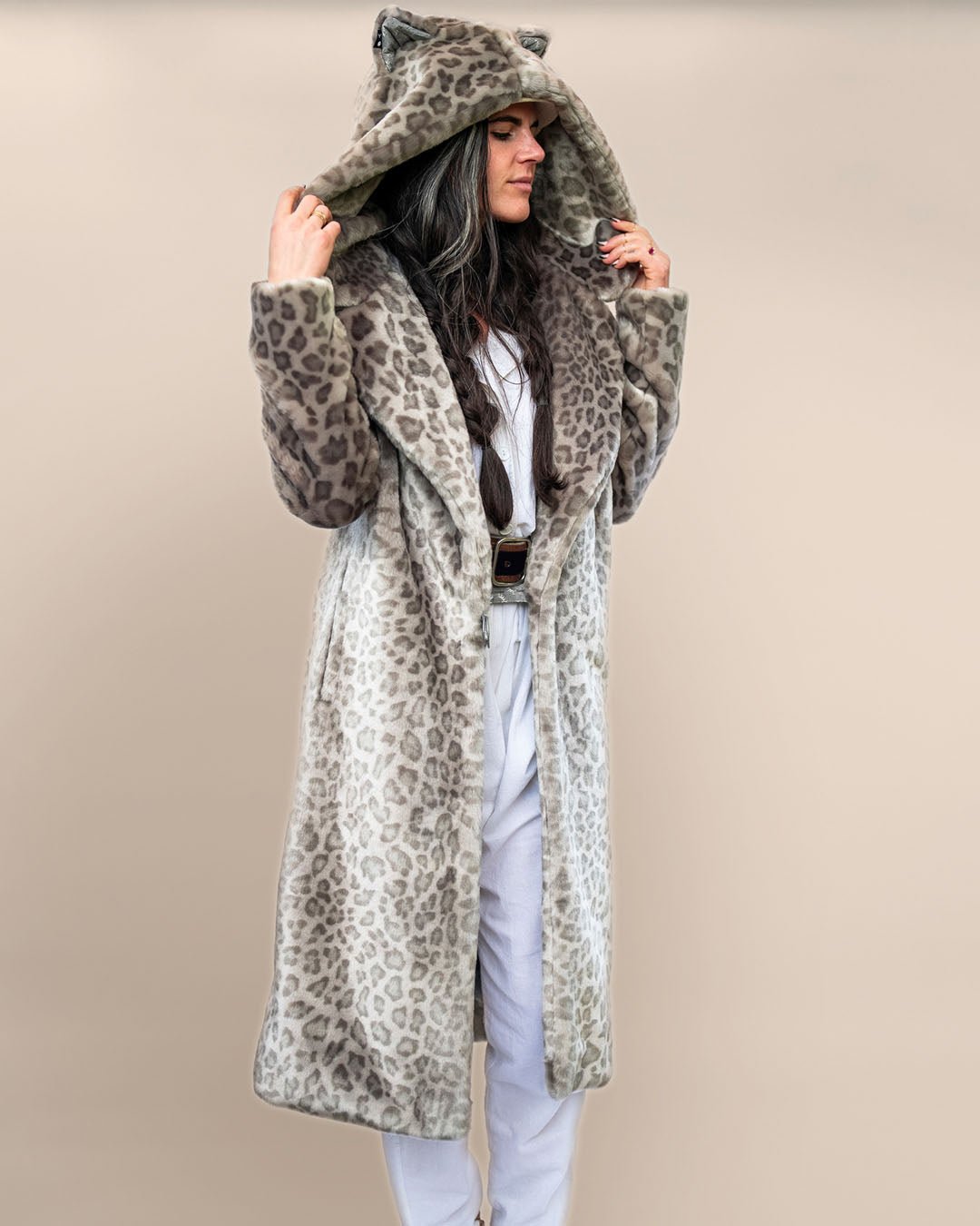 Girl with whimsical look, arms swaying, in Classic Women’s Long Silver Leopard Faux Fur Coat with hood and ears up, belt secured.