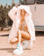 Female model kneels in the desert, showcasing her Flamingo Wolf Classic Faux Fur Jacket and platform white space boots.