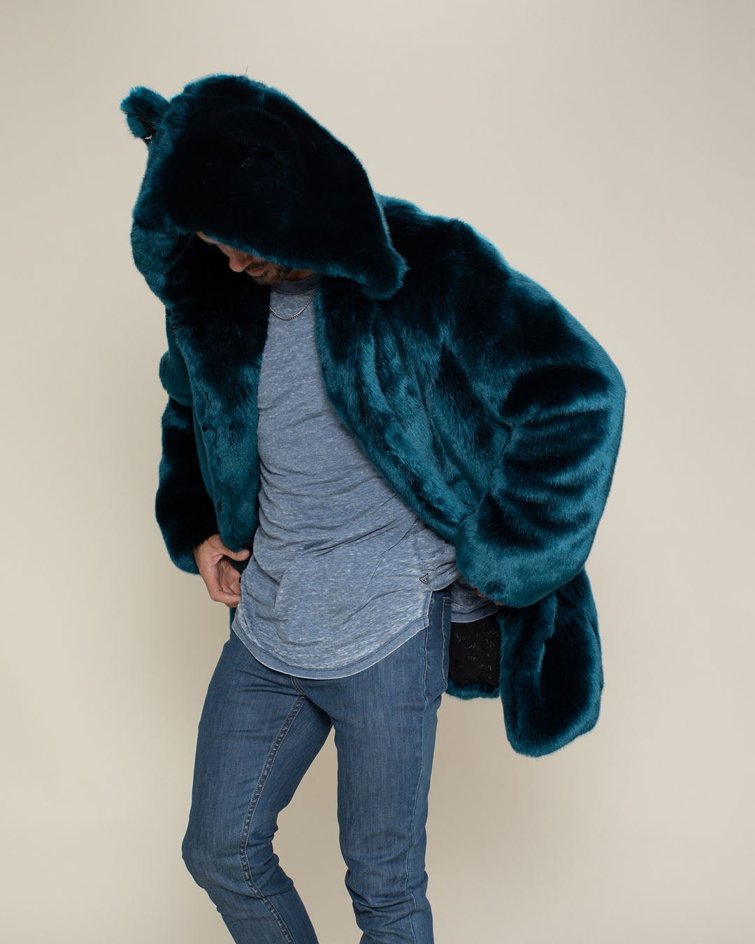 Dude slightly bending forward in a Royal Wolf Classic faux fur coat with the hood and ears on.