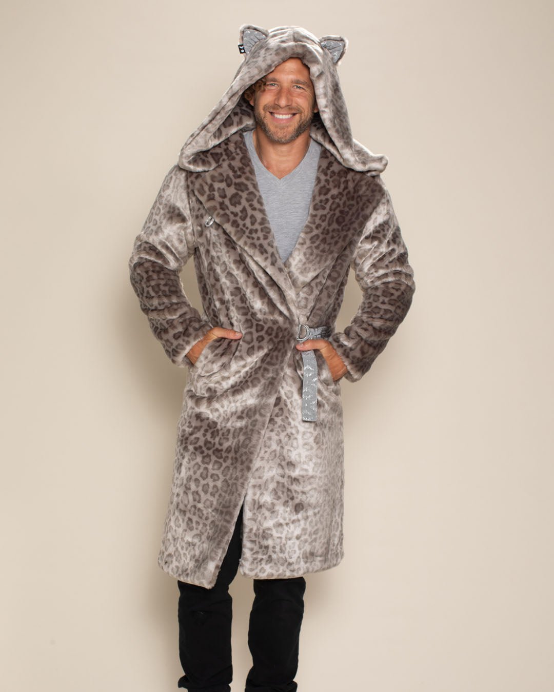 Handsome man smiling with hands in the pockets of the belted Silver Leopard Classic Long Faux Fur Jacket.