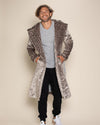 Happy male model wearing the Long Classic Vegan Fur Silver Leopard Coat, with hands in pockets and hood down.