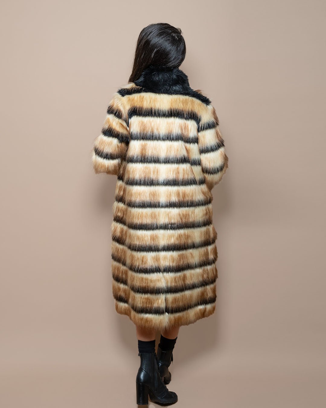 Dark-haired model, hair swept aside, showcasing the full back of the Collared Gazelle Long Faux Fur Jacket. Bold and chic.