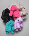 Photo of various colors of fluffy bunny keychains.