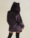 Female model with knee highs with back turned to camera wearing dark purple midnight wolf fake fur coat.