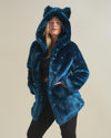 Blonde curvy model with a come-hither stare, hands in pockets, posing in the Royal Wolf Classic faux fur coat.