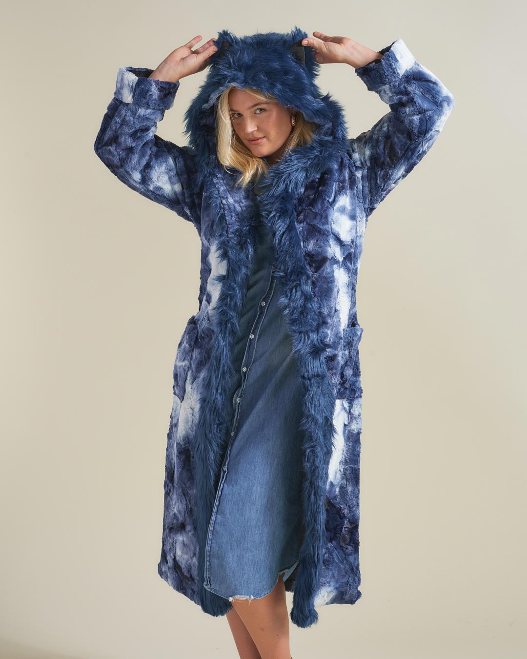 Blonde Model Holding Ears on Hood of Classic Faux Fur Robe Featuring Water Wolf Design