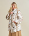 Sweet faced blonde model turned to one side showing off side pocket of a Siberian Snow leopard fake sure coat. 