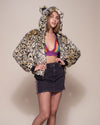 Woman wearing Ocelot Luxe Classic Faux Fur Bomber Jacket, side view