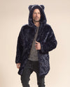 Serious, handsome man holding the middle lapel of the Indigo Leopard Collector Edition Faux Fur Jacket, hood and ears up. Striking and stylish.