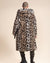 Shaved-head male model with back to camera in Classic Men's Long Vegan Fur Coat in Arabian Leopard Print, open with hood and ears down.