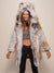 Cute, smiling girl looking down while wearing a realistic faux fur Classic Arctic Fox coat with the hood and ears up, arms slightly outstretched away from her body.