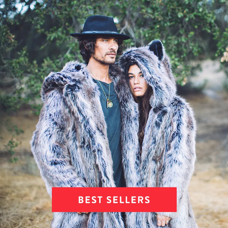 Man and woman outside wearing grey wolf faux fur coats