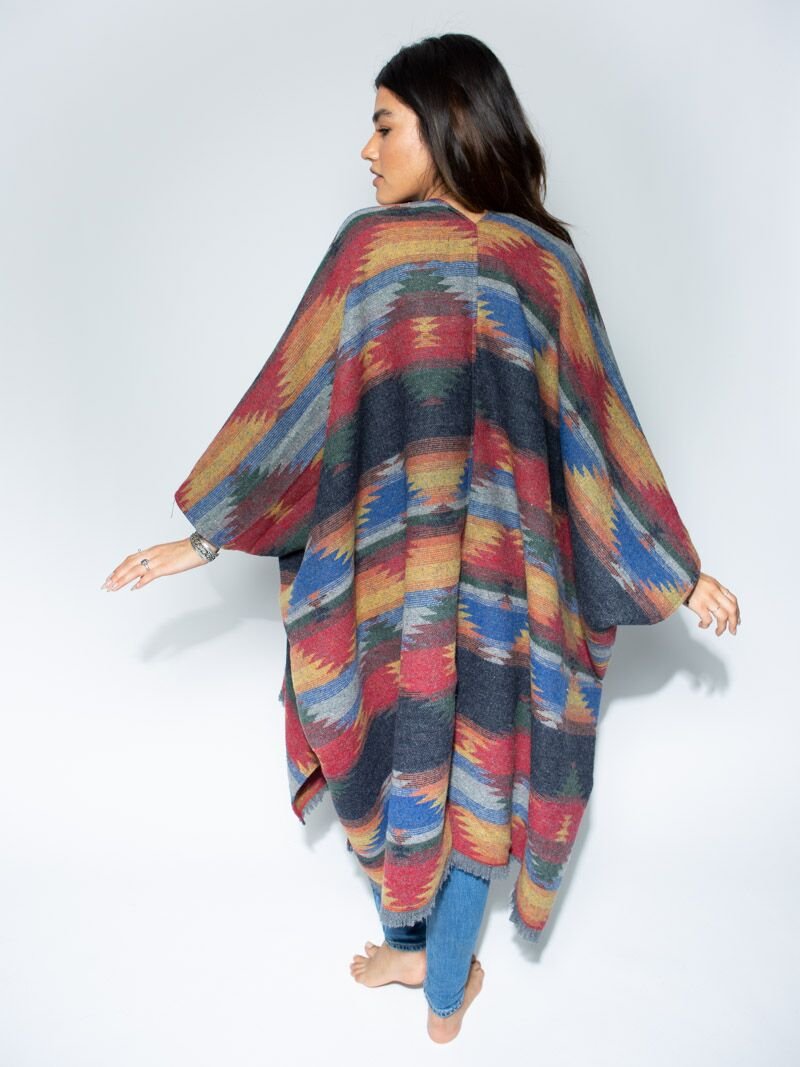 Woman wearing Dire Wolf Fabric Poncho, front view 1