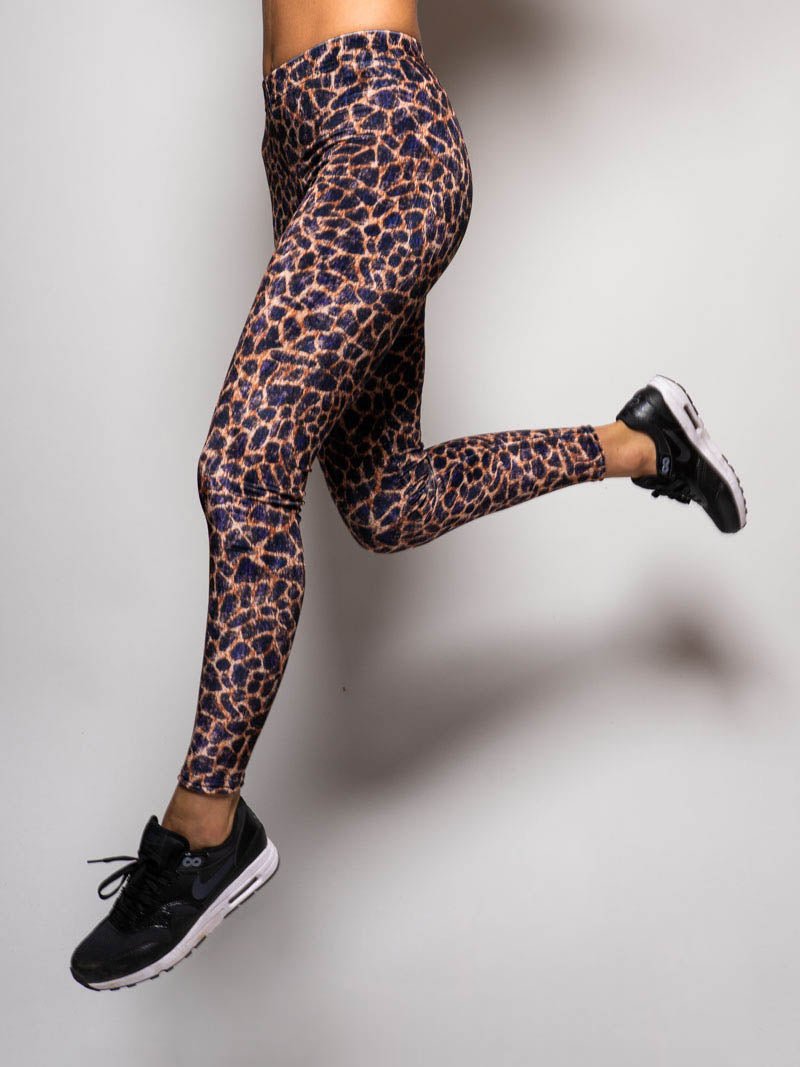 Woman Jumping in Purple Cheetah Velvet Leggings