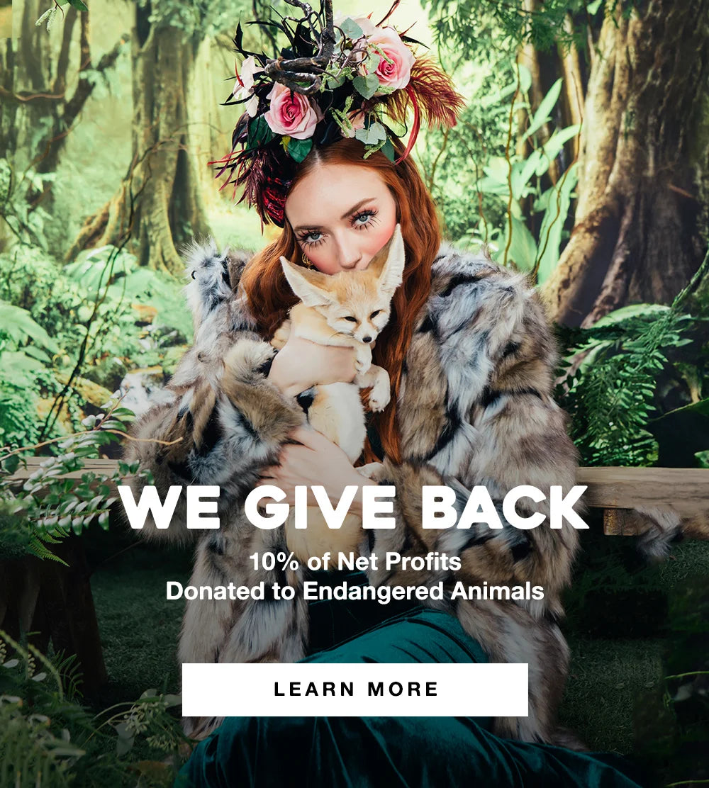 Red head girl holding a fennel fox and wearing a wolverine faux fur coat 