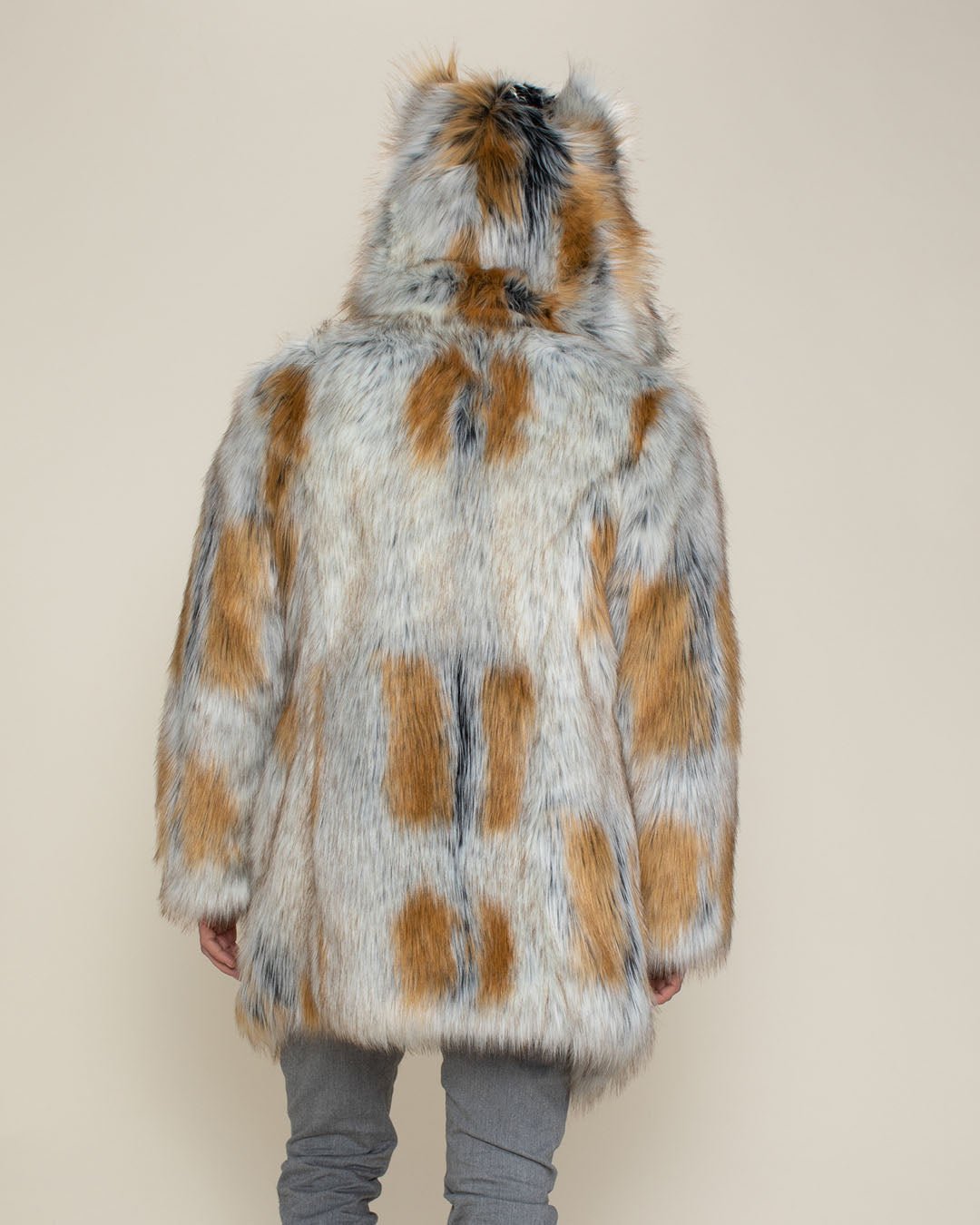 A full back view of the Arctic Fox vegan fur coat with the hood and ears up, worn by a male model.