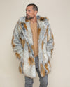 A handsome man with his hands in the pockets of his realistic Classic Arctic Fox fur coat, with the hood and ears down, looking to one side.