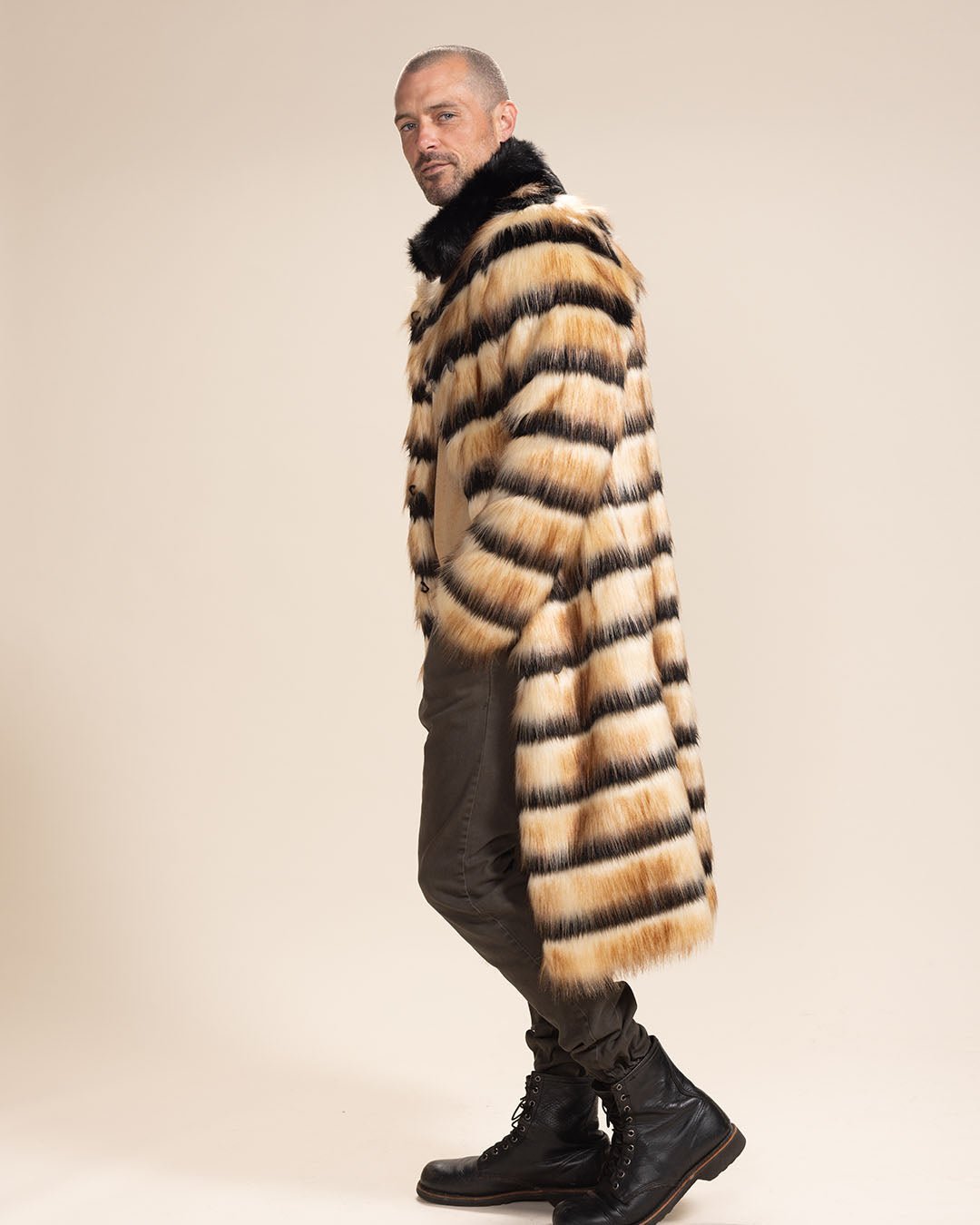 Handsome man with a sly smile facing to one side, hands in pockets of Long Collared Gazelle Faux Fur Jacket.