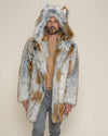 A guy with his hands at his sides, wearing a faux fur jacket called the Classic Arctic Fox, with the hood and ears up.