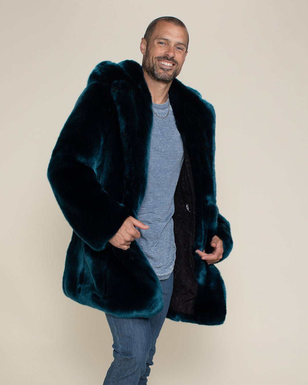 Smiling man holding the lower lapels of his vegan fur Royal Wolf Classic Coat, showcasing a stylish and handsome look.