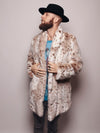 A bearded male model in a fedora has both hands on the lower lapels of a collared faux fur coat called the Siberian snow leopard.