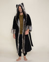 A happy, handsome male model wearing a faux fur Grey Wolf robe with the hood and ears up.