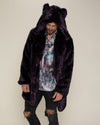 Male with short mustache and beard looking down while wearing dark purple fake fur midnight wolf coat with hood and ears up. 