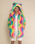 Sly guy wearing Rainbow Bear Classic faux fur coat with hands in pockets, hood, and ears up.