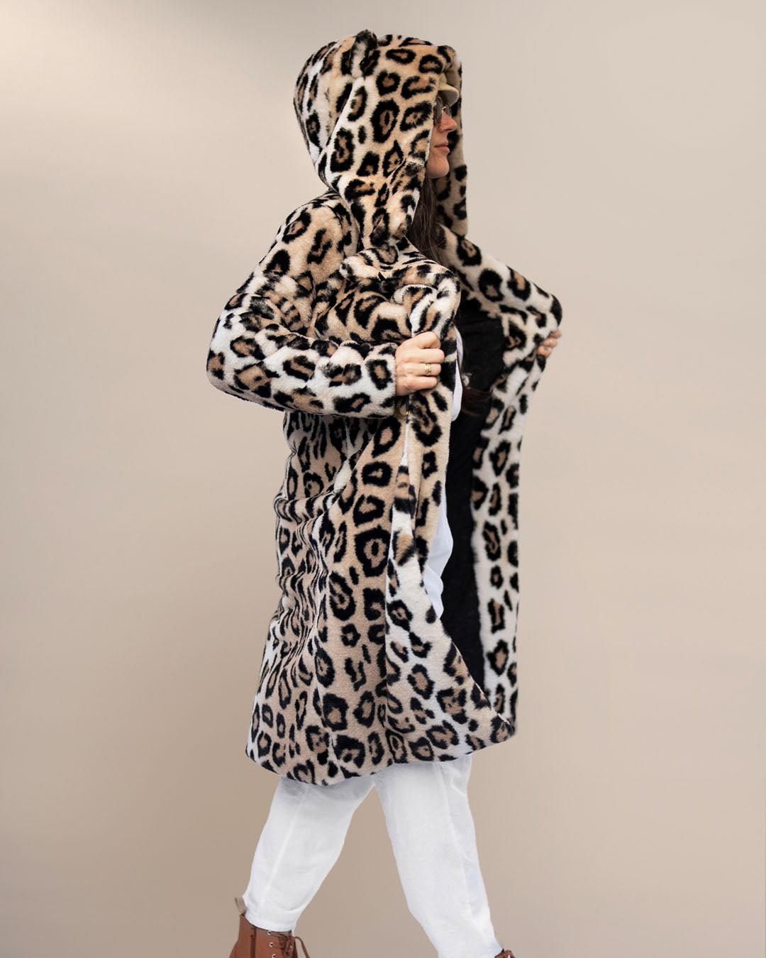 Dark-haired model in sunglasses, head turned to the side, in beige beret holding lapels of Classic Women's Long Faux Fur Coat in Arabian Leopard Print.