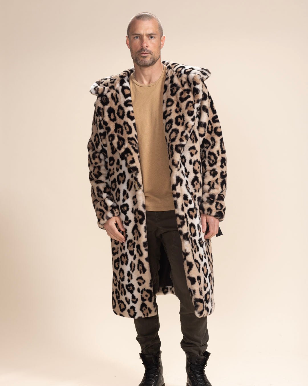 Provocative male model staring at the camera in the open Arabian Leopard Classic Long Vegan Coat, hands at sides, hood and ears down. Striking style.