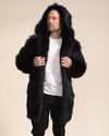 A man is looking into the distance while wearing a realistic black wolf coat with the hood up, holding the lapels.