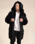 A man is looking into the distance while wearing a realistic black wolf coat with the hood up, holding the lapels.