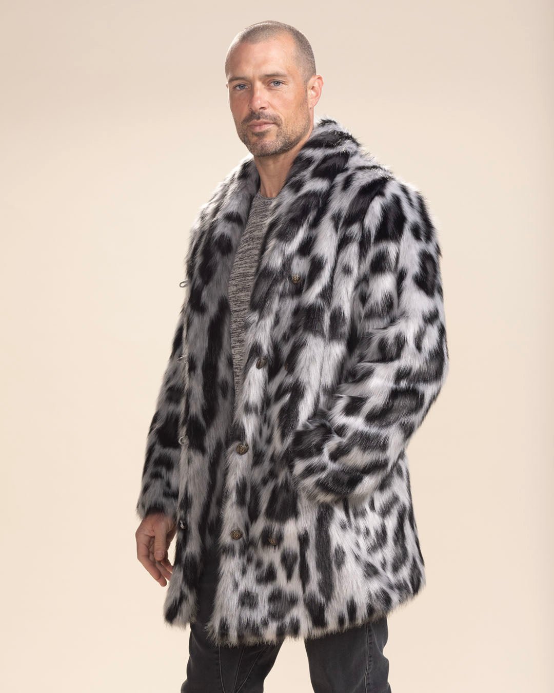 Handsome man with a come-hither gaze, hand in pocket of Collared Himalayan Snow Leopard vegan fur coat. Striking look.