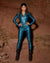 Women with dark hair standing infront of red rock formation wearing bright blue viper reflective bodysuit by spirithoods