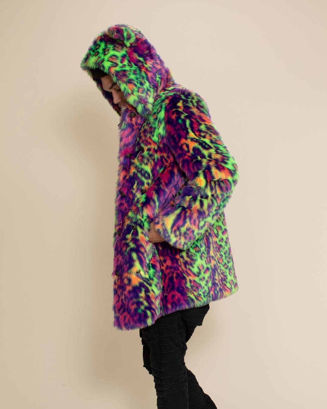 Man facing sideways with hands in pockets of Disco Cat Leopard Classic fake fur coat, hood and ears up. Cozy, playful outerwear.