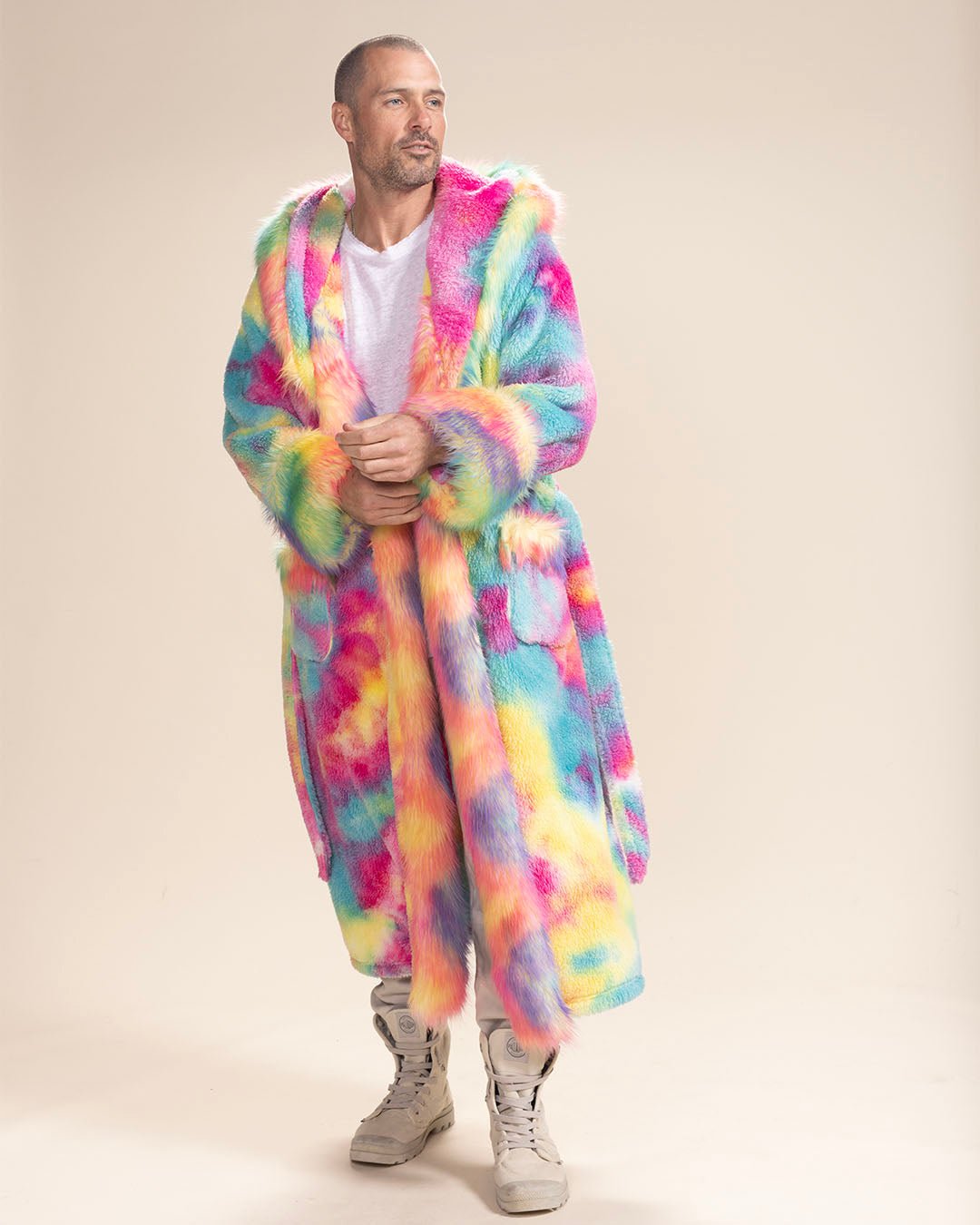 Handsome man gazing ahead in a closed Classic Rainbow Bear Faux Fur Robe, arms crossed, hood down, untied belt. Cozy, bold style.