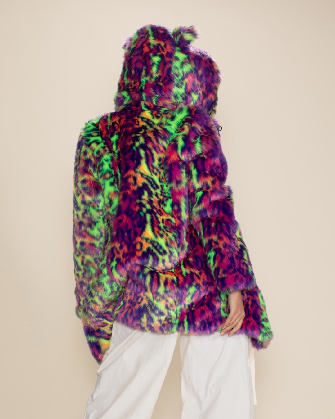 Girl stands sassily with her back to the camera, showing off the full Neon Disco Cat vegan fur coat.