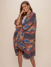 Woman wearing Dire Wolf Fabric Poncho, front view 1