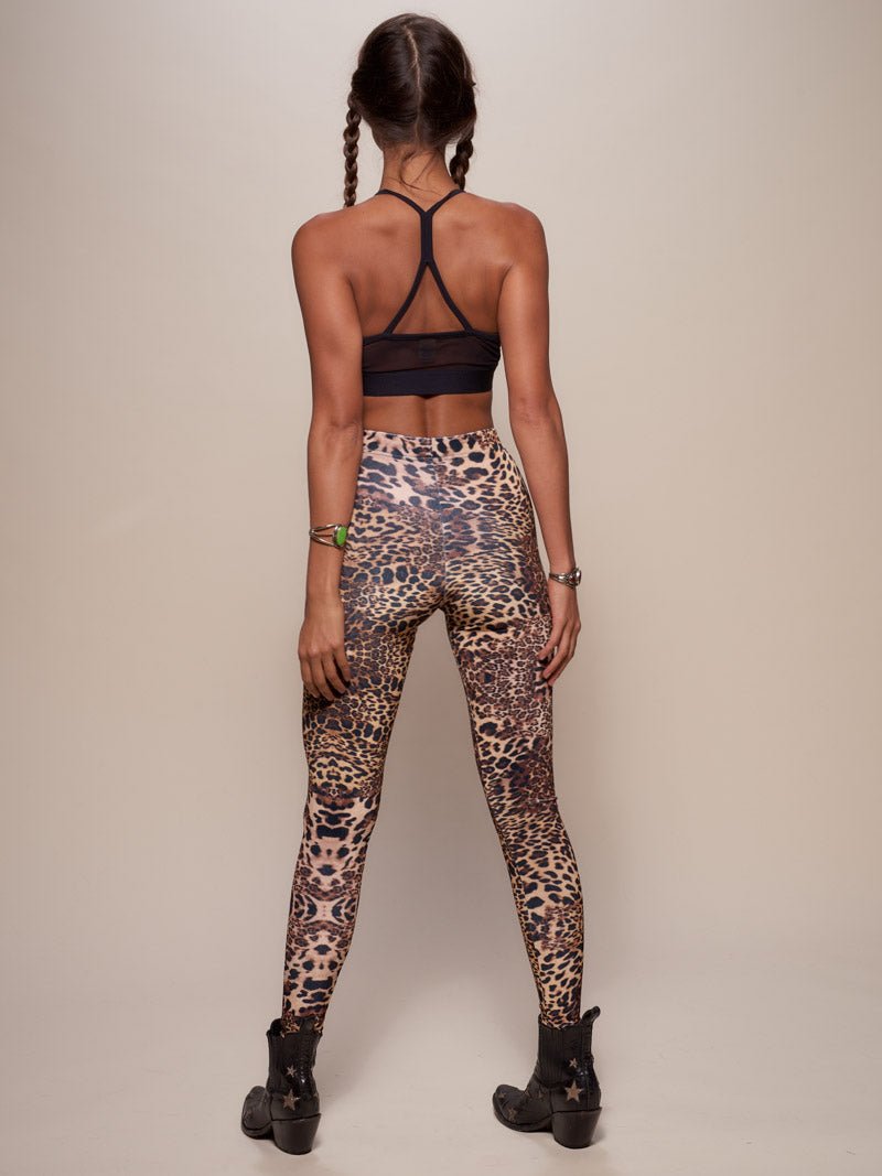 Woman wearing Amur Leopard Velvet Leggings, back view