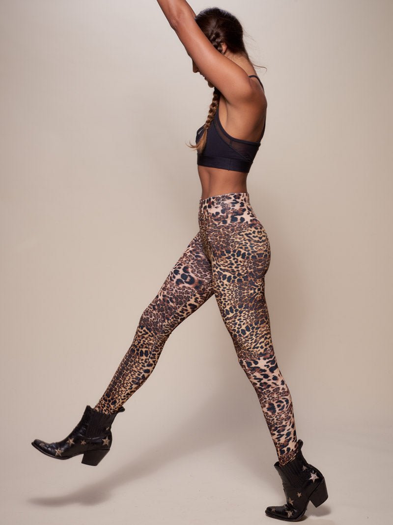 Woman wearing Amur Leopard Velvet Leggings, side view 1