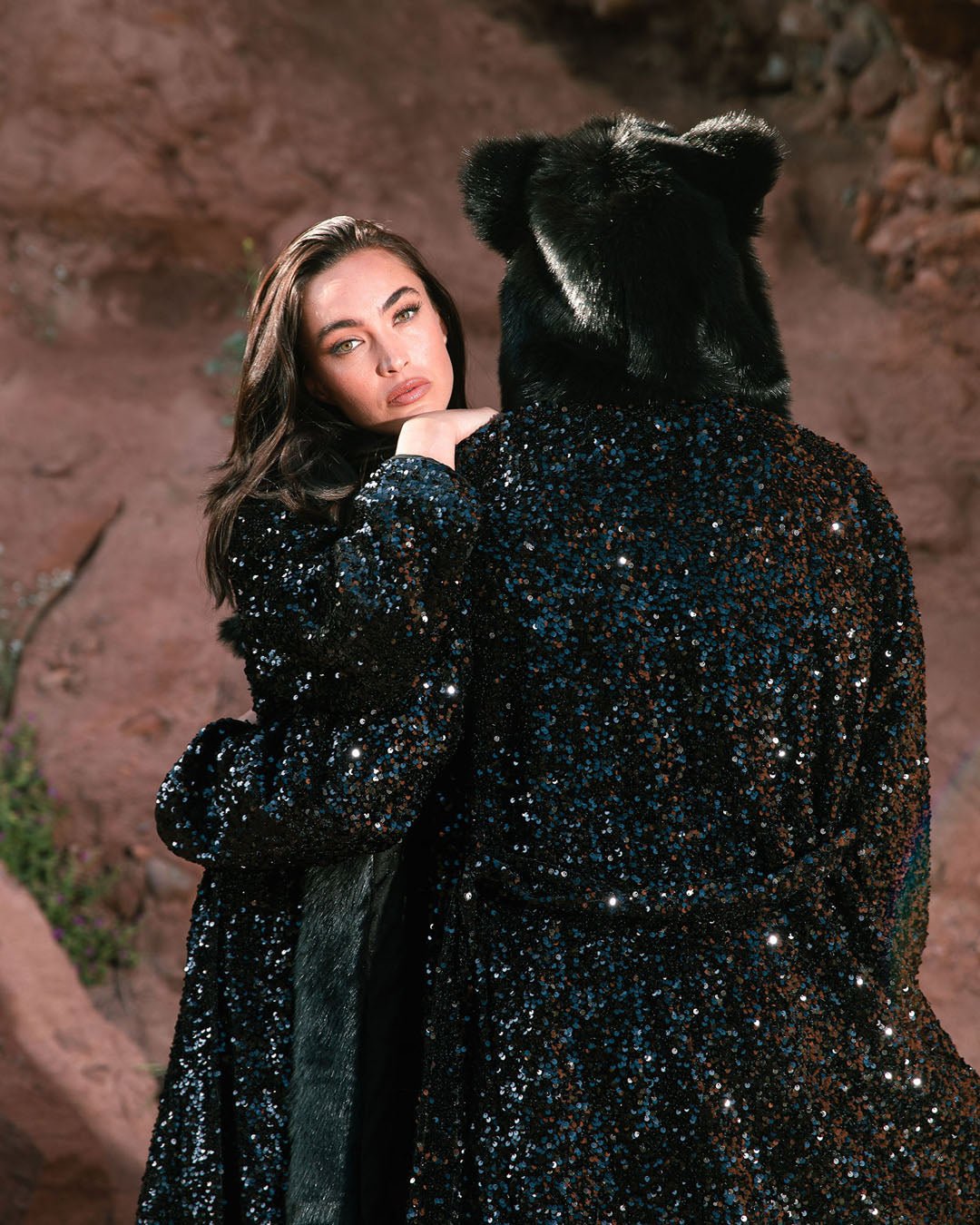 Woman and Man embracing each other in nature, each wearing the Sequin Black Panther SpiritHood Style Robes