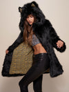 Woman wearing Collector Edition Black Wolf Faux Fur Coat, side view