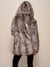 Female model with entire back to camera, wearing artificial hooded grey wolf coat, with the hood up on her head.