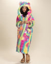 Smiling dark-haired beauty holding lapels of closed Rainbow Bear Faux Fur Robe, hood and ears up, with belt undone. Cozy, stylish look