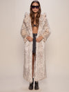 Woman wearing Baby Snow Leopard Classic Long Faux Fur Coat, front view 1