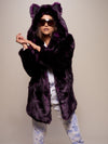 Girl in sunglasses posing in a purple midnight wolf fake fur jacket with hood and ears up. 