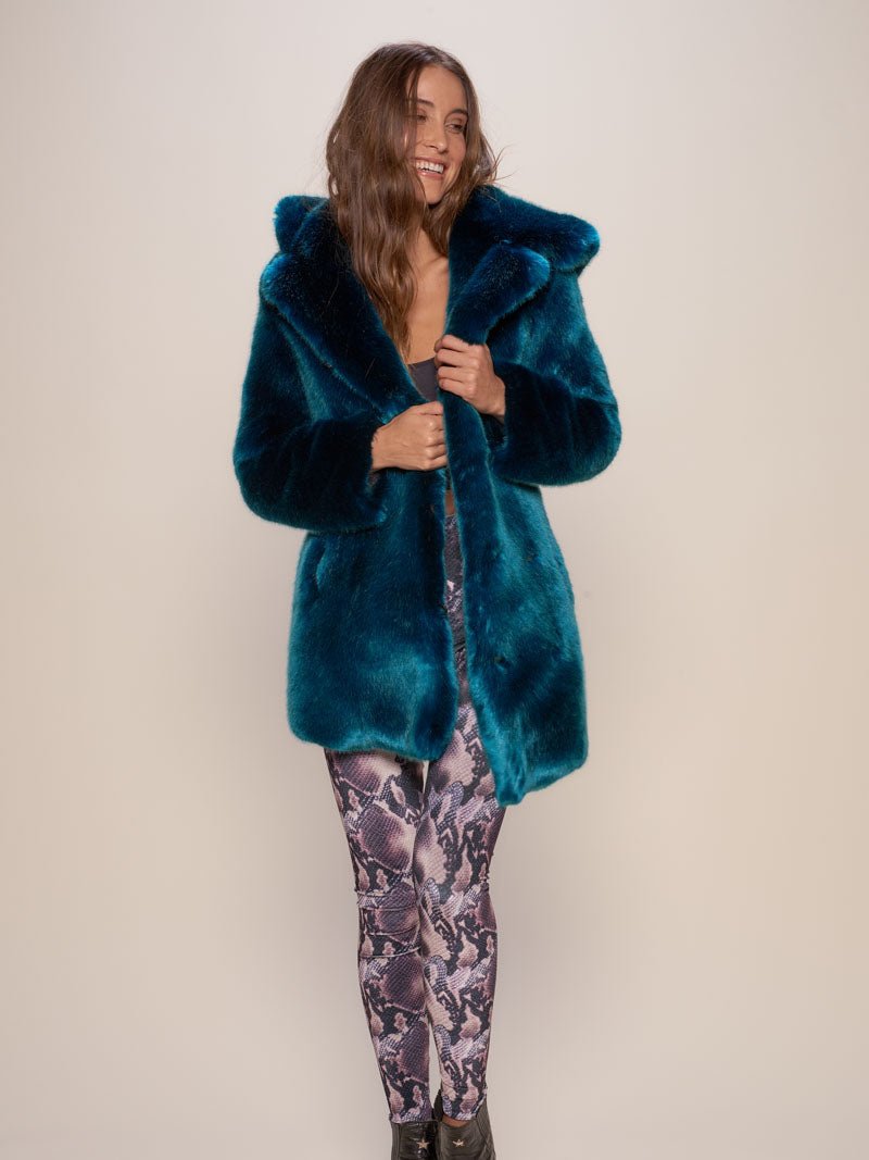 Happy brown-haired model holding the lapels of the Classic Royal Wolf Luxe faux fur coat and looking to one side.